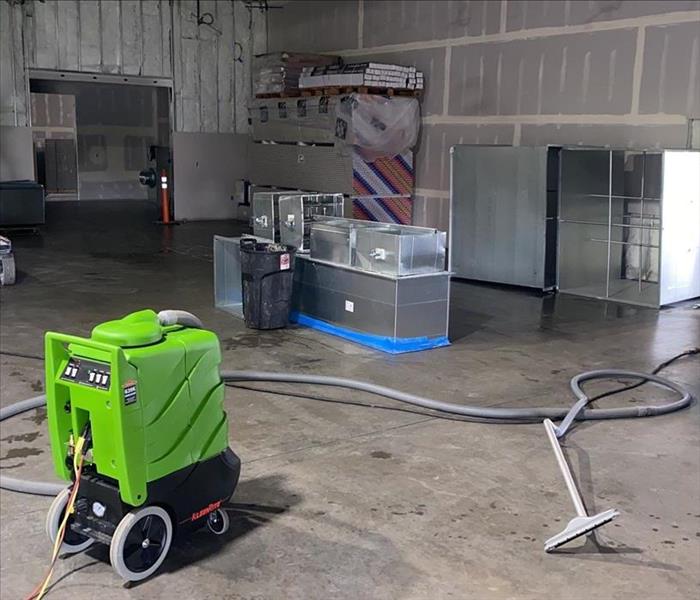 SERVPRO extractor sitting on the floor of a warehouse