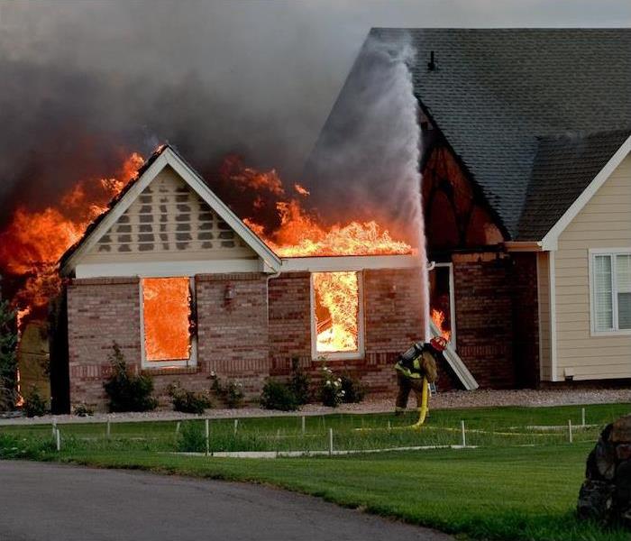 man battling house fire